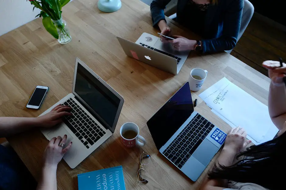 A group of people working on laptops and writing, representing freelance websites for content writers