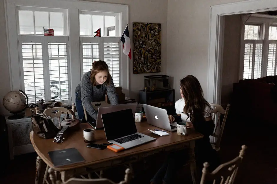 A person sitting at a desk with a laptop and editing a document.