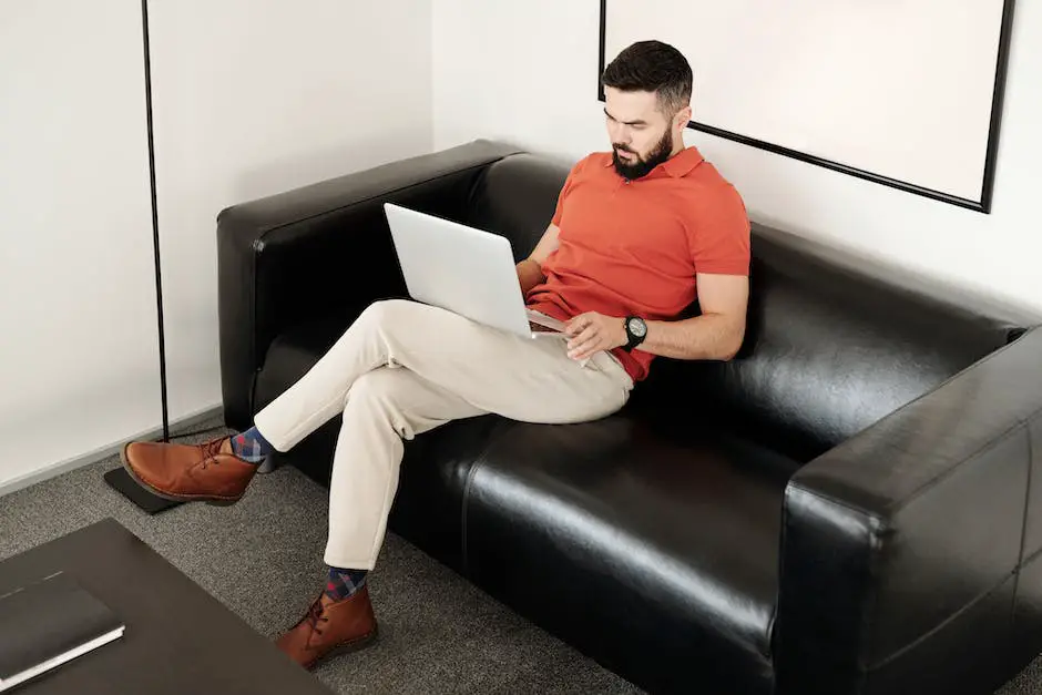Image of a person using a laptop while sitting on a couch, representing an online reselling business